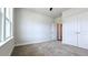 This bedroom features plush carpeting, natural light, and a spacious closet at 621 Pineberry Ct, Grayson, GA 30017