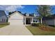 Charming single-Gathering home featuring a two-car garage, dormer windows, and well-maintained landscaping at 621 Pineberry Ct, Grayson, GA 30017
