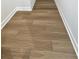 Close-up of beautiful wood-look tile flooring with white baseboards creating a clean and modern aesthetic at 621 Pineberry Ct, Grayson, GA 30017