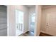 Inviting hallway featuring wood floors, a linen closet, access to a bathroom, and an open doorway to a bedroom at 621 Pineberry Ct, Grayson, GA 30017