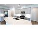 Well-lit kitchen featuring gray cabinets, a pantry, stainless steel appliances, and a quartz countertop island at 621 Pineberry Ct, Grayson, GA 30017