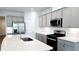 Bright kitchen featuring gray cabinets, stainless steel appliances, a quartz countertop island, and modern fixtures at 621 Pineberry Ct, Grayson, GA 30017