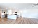 Spacious open-concept kitchen with gray cabinets, stainless steel appliances, an island, and hardwood floors at 621 Pineberry Ct, Grayson, GA 30017