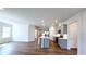 Spacious open-concept living area with gray cabinets, stainless steel appliances, an island, and hardwood floors at 621 Pineberry Ct, Grayson, GA 30017