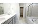 This light-filled main bathroom features a walk-in shower, soaking tub, and double vanity at 621 Pineberry Ct, Grayson, GA 30017