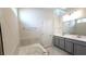 This main bathroom includes a soaking tub, double vanity with framed mirrors, and tile flooring at 621 Pineberry Ct, Grayson, GA 30017