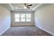 This airy main bedroom features large windows, neutral walls, plush carpeting, and a ceiling fan at 621 Pineberry Ct, Grayson, GA 30017