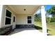 Covered patio with stone accents, offering a peaceful outdoor space and yard view at 621 Pineberry Ct, Grayson, GA 30017