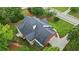Aerial view showcasing the home's backyard, deck, landscaping, and driveway at 1253 Oakwood Pl, Loganville, GA 30052