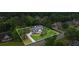 Overhead view of home nestled on a lush lot with mature trees, surrounded by a verdant landscape at 1253 Oakwood Pl, Loganville, GA 30052