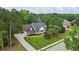 Beautiful aerial view of a brick home with well-manicured lawn and mature trees at 1253 Oakwood Pl, Loganville, GA 30052