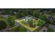 An aerial view of a two-story brick home with lush landscaping and mature trees at 1253 Oakwood Pl, Loganville, GA 30052