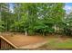 Expansive backyard featuring lush trees providing ample shade and privacy at 1253 Oakwood Pl, Loganville, GA 30052