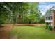 Lush backyard with mature trees and a screened porch, creating a serene and private oasis at 1253 Oakwood Pl, Loganville, GA 30052