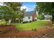Spacious backyard showcasing a well-maintained lawn, landscaping, and covered deck space at 1253 Oakwood Pl, Loganville, GA 30052