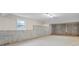Unfinished basement with concrete walls, window and lighting at 1253 Oakwood Pl, Loganville, GA 30052