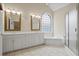 Bathroom with dual vanities, soaking tub, and walk-in shower at 1253 Oakwood Pl, Loganville, GA 30052