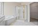 Bright bathroom featuring a bathtub and shower combo at 1253 Oakwood Pl, Loganville, GA 30052