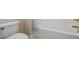 Bathroom featuring a white toilet and bath with gold hardware at 1253 Oakwood Pl, Loganville, GA 30052