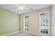 Light-filled bedroom with two windows, neutral walls, and a ceiling fan at 1253 Oakwood Pl, Loganville, GA 30052