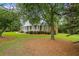 Beautiful brick home with covered front porch and meticulously maintained lawn at 1253 Oakwood Pl, Loganville, GA 30052