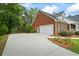 Spacious two-car garage with extended driveway and well-maintained landscaping at 1253 Oakwood Pl, Loganville, GA 30052