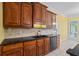 Close up of a kitchen featuring dark wood cabinets and a black double basin sink at 1253 Oakwood Pl, Loganville, GA 30052