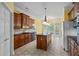 Eat-in kitchen featuring a kitchen island, dark wood cabinets and tile floors at 1253 Oakwood Pl, Loganville, GA 30052