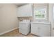 Functional laundry room with washer, dryer, cabinet and sink at 1253 Oakwood Pl, Loganville, GA 30052