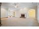 Spacious living room featuring a fireplace, neutral carpet, and plenty of natural light at 1253 Oakwood Pl, Loganville, GA 30052