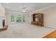 Bright living room with fireplace, large windows, and built-in shelving at 1253 Oakwood Pl, Loganville, GA 30052