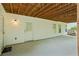 Covered patio featuring white siding, exterior lighting, and concrete flooring at 1253 Oakwood Pl, Loganville, GA 30052