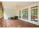 Relaxing screened porch featuring a ceiling fan, wood floors, and views of the yard at 1253 Oakwood Pl, Loganville, GA 30052