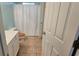 Bathroom featuring a toilet and shower with a white shower curtain at 13030 Crabapple Lake Dr, Roswell, GA 30076