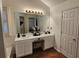 This well-lit bathroom features dual sinks, ceramic tile flooring, and a large mirror at 13030 Crabapple Lake Dr, Roswell, GA 30076