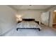 Large bedroom boasts a ceiling fan, carpeted floors and an adjacent bathroom at 13030 Crabapple Lake Dr, Roswell, GA 30076