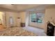 This carpeted bedroom features a ceiling fan, a window, and a full length mirror at 13030 Crabapple Lake Dr, Roswell, GA 30076