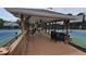 Relaxing community gazebo with ceiling fans overlooking the tennis courts, providing a comfortable social gathering space at 13030 Crabapple Lake Dr, Roswell, GA 30076