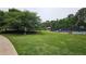 Expansive green space with tennis court, playground, and other recreational activities at 13030 Crabapple Lake Dr, Roswell, GA 30076
