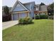 Charming two-story home with a well-manicured lawn and an attached two-car garage at 13030 Crabapple Lake Dr, Roswell, GA 30076