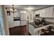Updated kitchen with stainless steel appliances, black countertops, and stylish barstool seating at the island at 13030 Crabapple Lake Dr, Roswell, GA 30076