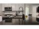 Modern kitchen features granite countertops, stainless steel appliances, and white cabinets at 13030 Crabapple Lake Dr, Roswell, GA 30076