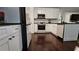 Updated kitchen features modern white cabinets, stainless appliances, and dark hardwood floors at 13030 Crabapple Lake Dr, Roswell, GA 30076