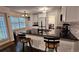 Bright kitchen featuring black countertops, white cabinets, stainless appliances, and an open design to the dining area at 13030 Crabapple Lake Dr, Roswell, GA 30076