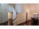 Spacious living area showcasing a staircase, dining room, and beautiful hardwood flooring throughout the home at 13030 Crabapple Lake Dr, Roswell, GA 30076