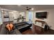 Open-concept living room with hardwood floors, a ceiling fan, and access to the kitchen at 13030 Crabapple Lake Dr, Roswell, GA 30076