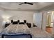 This main bedroom has a carpeted floor and doorway to a bathroom at 13030 Crabapple Lake Dr, Roswell, GA 30076