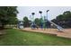 Community playground featuring multiple slides, climbing structures, and a soft landing surface at 13030 Crabapple Lake Dr, Roswell, GA 30076