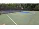 Well-maintained tennis and basketball court with new black fencing in a quiet residential neighborhood at 13030 Crabapple Lake Dr, Roswell, GA 30076