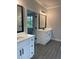 Bright bathroom featuring double vanities, wood-look flooring, and modern matte black fixtures at 2021 Shallowford Rd, Marietta, GA 30066